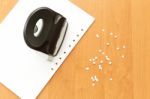 Hole Puncher With Paper On The Office Table, Paper With Holes Stock Photo