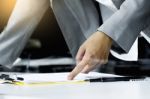 Close-up Of Human Hand With Pen Pointing At Paper While Explaini Stock Photo