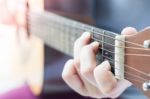 Woman's Hands Playing Acoustic Guitar Stock Photo