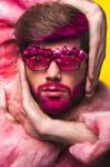 Man In A Pink Fur Coat And Carnival Glasses Stock Photo