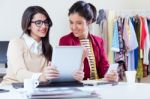 Two Young Businesswomen Working With Digital Tablet In Her Offic Stock Photo