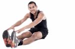 Fit Guy Doing Stretching Exercise Stock Photo