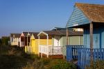 Beach Huts Bathed In Warm Evening Sunlight Stock Photo