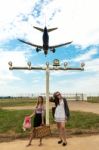 Two Girls Hitchhiking A Plane Stock Photo