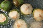 Fresh Coconuts Float Above Ice And Water Stock Photo