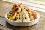 Homemade Ice Cream Dessert With Toasts, Raisins, Cashew Nuts, And Whip Cream In White Ceramic Bowl Stock Photo