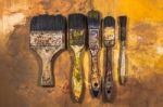 Oil Paint Brushes On Wood Painted Background Stock Photo