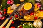 Christmas Baked Duck Served With Potatoes, Orange And Tomatoes Stock Photo