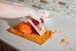 Woman Cooks The Beets On A Grater Stock Photo