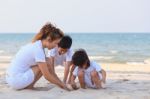 Asian Family Play Sand On Beach Stock Photo