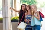 Group Of Beautiful Girls Looking At The Shop Window Stock Photo