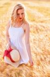 Lonely Beautiful Young Blonde Girl In White Dress With Straw Hat Stock Photo