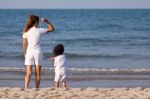 Asian Mom And Son On Beach Stock Photo