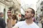 male Photographer With Mobile Phone Stock Photo