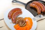 Beef Sausages Cooked On Iron Skillet Stock Photo