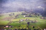 Alpine Village In Mountains. Smoke And Haze Over Hills Stock Photo