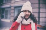 Woman In Red Coat And Wool Cap And Gloves With Smartphone In Han Stock Photo