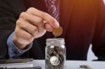 Hand Putting Mix Coins And Seed In Clear Bottle And Copyspace, B Stock Photo