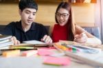 A Teenage Girl And Boy Doing Their Homework Together Stock Photo