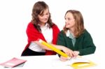 Girl Teaching to Her Friend Stock Photo