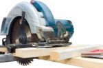 Circular Saw Cutting Wood And Iron Ruler Stock Photo