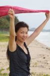 Woman Smiling On A Tropical Beach Stock Photo