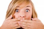 Closeup Of Young Women Covering Her Mouth With Both Hands Stock Photo