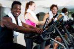 Gym Trainer Exercising Along With His Trainees Stock Photo