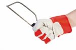 Glove Hand Holding Hacksaw Stock Photo