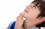 Cute Kid Thinking And Looking Up Stock Photo