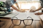 Architects Engineer Discussing At The Table With Blueprint - Clo Stock Photo