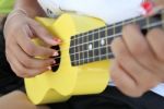 Closeup Of A Woman Playing Ukulele Stock Photo