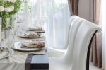 Table Set On Dark Brown Wooden Table In Dinning Room Stock Photo