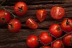 Organic Fresh Cherry Tomatoes On Wooden Background Stock Photo