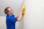 Elderly Worker Smoothing Wallpaper Stock Photo