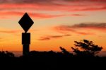 Road Sign Silhouette And Colorful Sunset Stock Photo