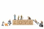 Miniature Worker Team Building Word Love On White Background Stock Photo