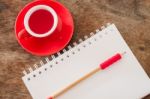 Red Mug With Open Notebook Stock Photo