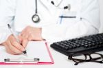 Doctor Writing On Clipboard Stock Photo