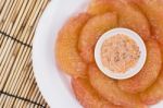 Pomelo In Dish On Mat Stock Photo