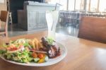 Delicious Barbecued Ribs And Lemon Soda Drink Stock Photo