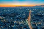 The Sun Sets Over The Cityscape Of Tokyo Stock Photo