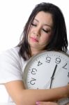 Sleepy Asian Woman Hug The Clock Stock Photo