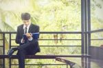 Young Businessman Looking At Report Paper Stock Photo