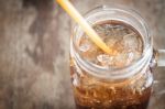 Glass Of Cola With Ice On Wooden Table Stock Photo