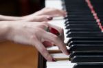 A Woman With Red Ring Playing Piano Stock Photo