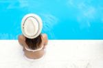 Pretty Girl Relaxing At The Swimming Pool In The Summertime Stock Photo