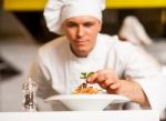 Chef Decorating Pasta Salad With Herbal Leaves Stock Photo