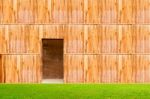 Wooden Wall With Door And Grass Floor In Front Off Stock Photo