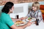 Couple Enjoying Dinner At A Restaurant Stock Photo